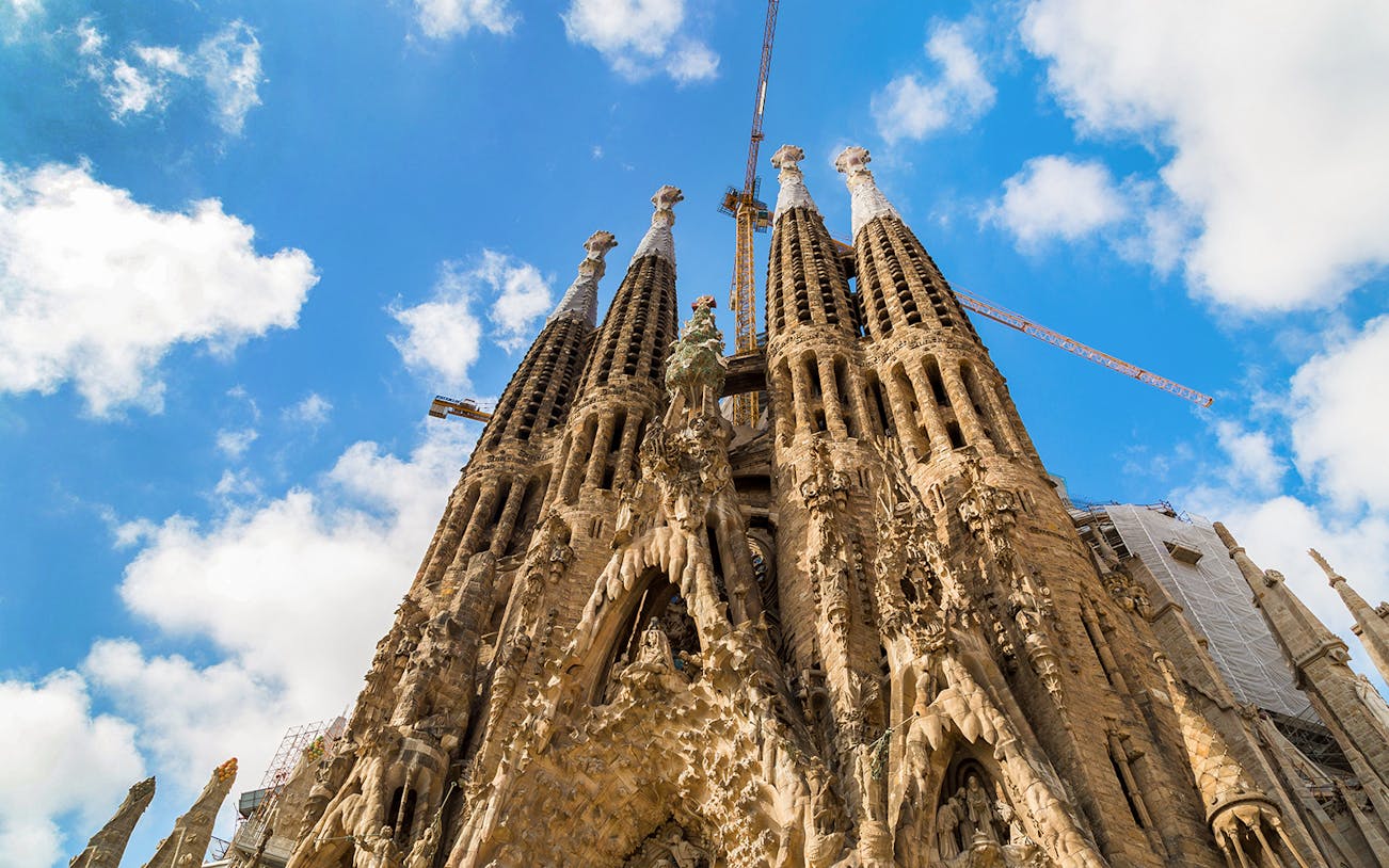 Sagrada Familia facade with intricate stone carvings and spires in Barcelona, Spain.