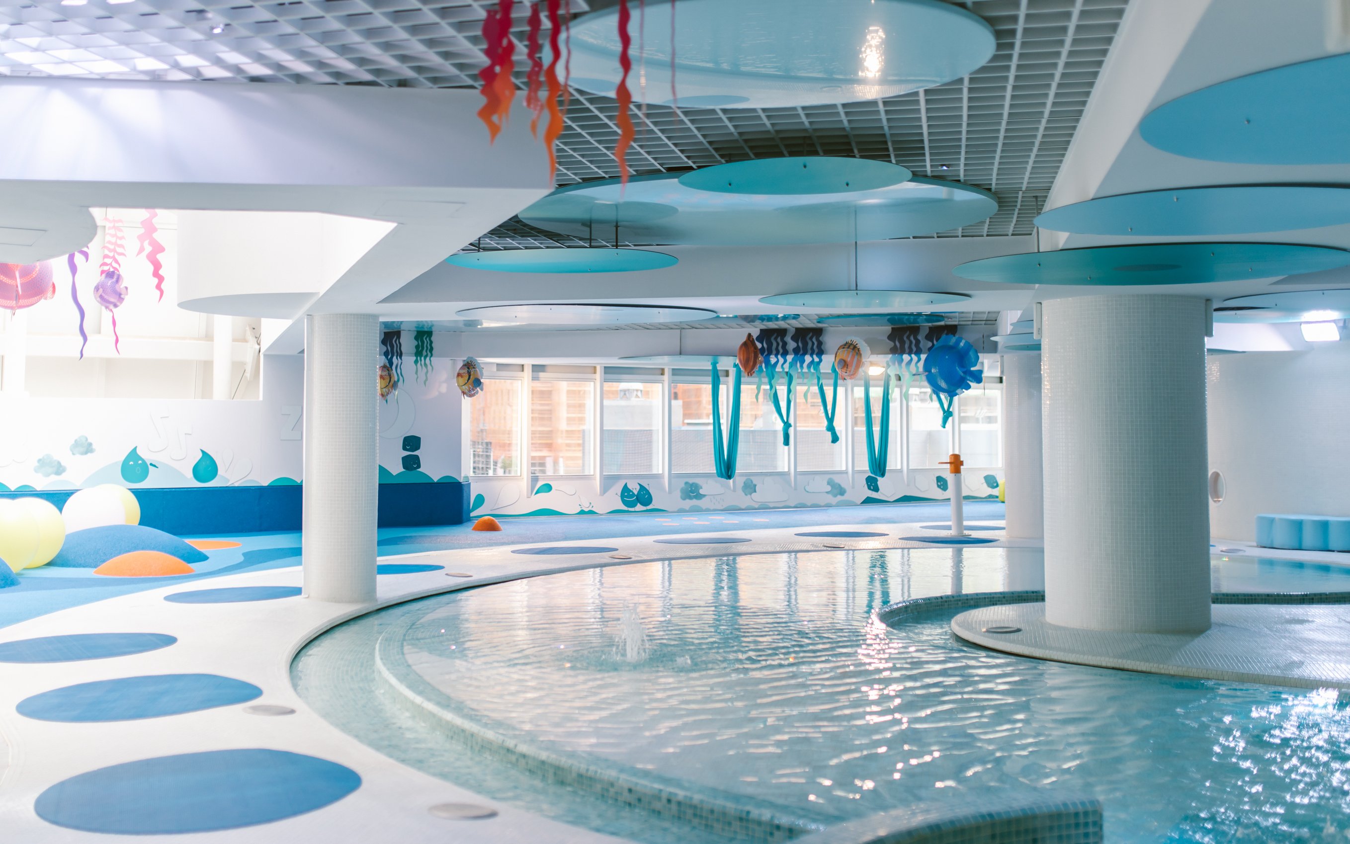 Children's play area with pool at Caldea spa, featuring colorful decor and water activities.