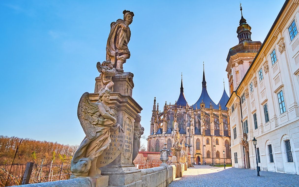Statues and St. Barbara's Church in Kutna Hora on a sunny day.