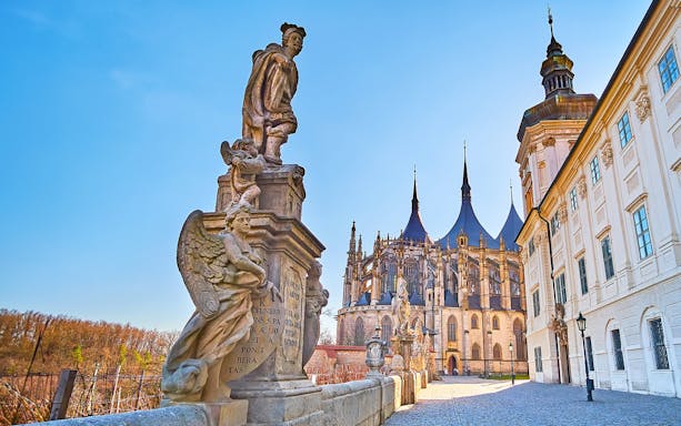 Statues and St. Barbara's Church in Kutna Hora on a sunny day.