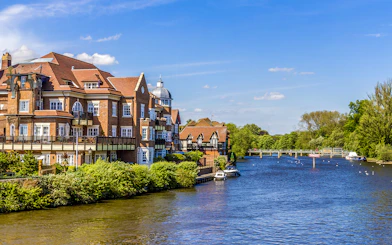 Riverside view with historic buildings and boats near London.