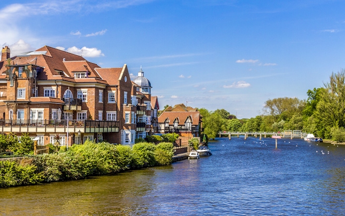 Riverside view with historic buildings and boats near London.