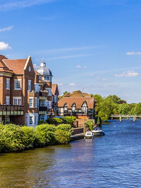Riverside view with historic buildings and boats near London.