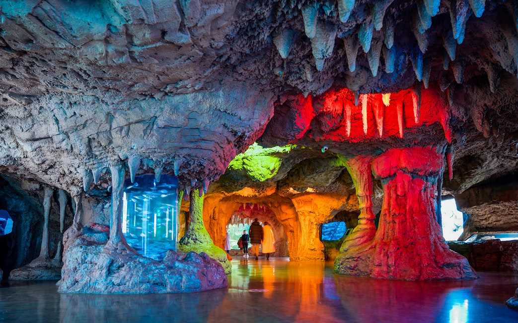 Interior cave-like exhibit with colorful lighting at Istanbul Aquarium, Turkey.