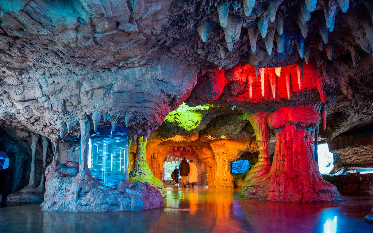 Interior cave-like exhibit with colorful lighting at Istanbul Aquarium, Turkey.
