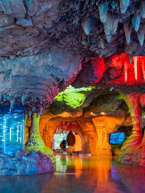 Interior cave-like exhibit with colorful lighting at Istanbul Aquarium, Turkey.
