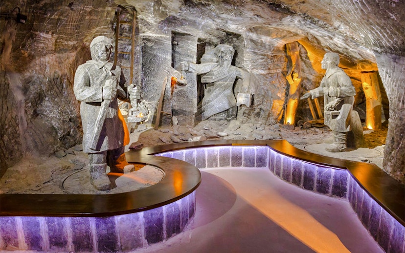 Wieliczka Salt Mine sculptures depicting miners with tools and lanterns.
