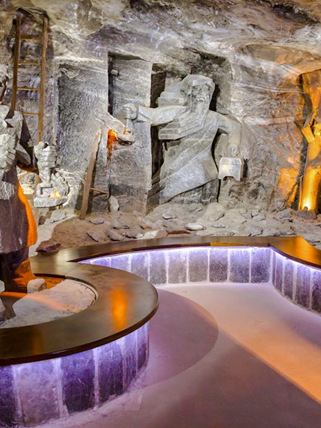 Wieliczka Salt Mine sculptures depicting miners with tools and lanterns.