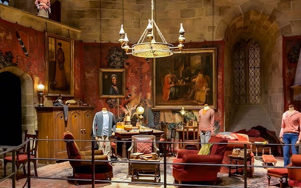 Gryffindor common room exhibit at Harry Potter London tour with costumes and decor.