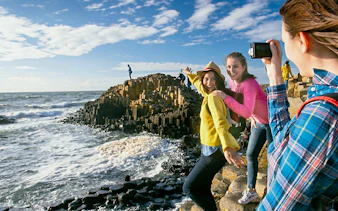 Visitors exploring the basalt columns at Giant's Causeway, Northern Ireland.