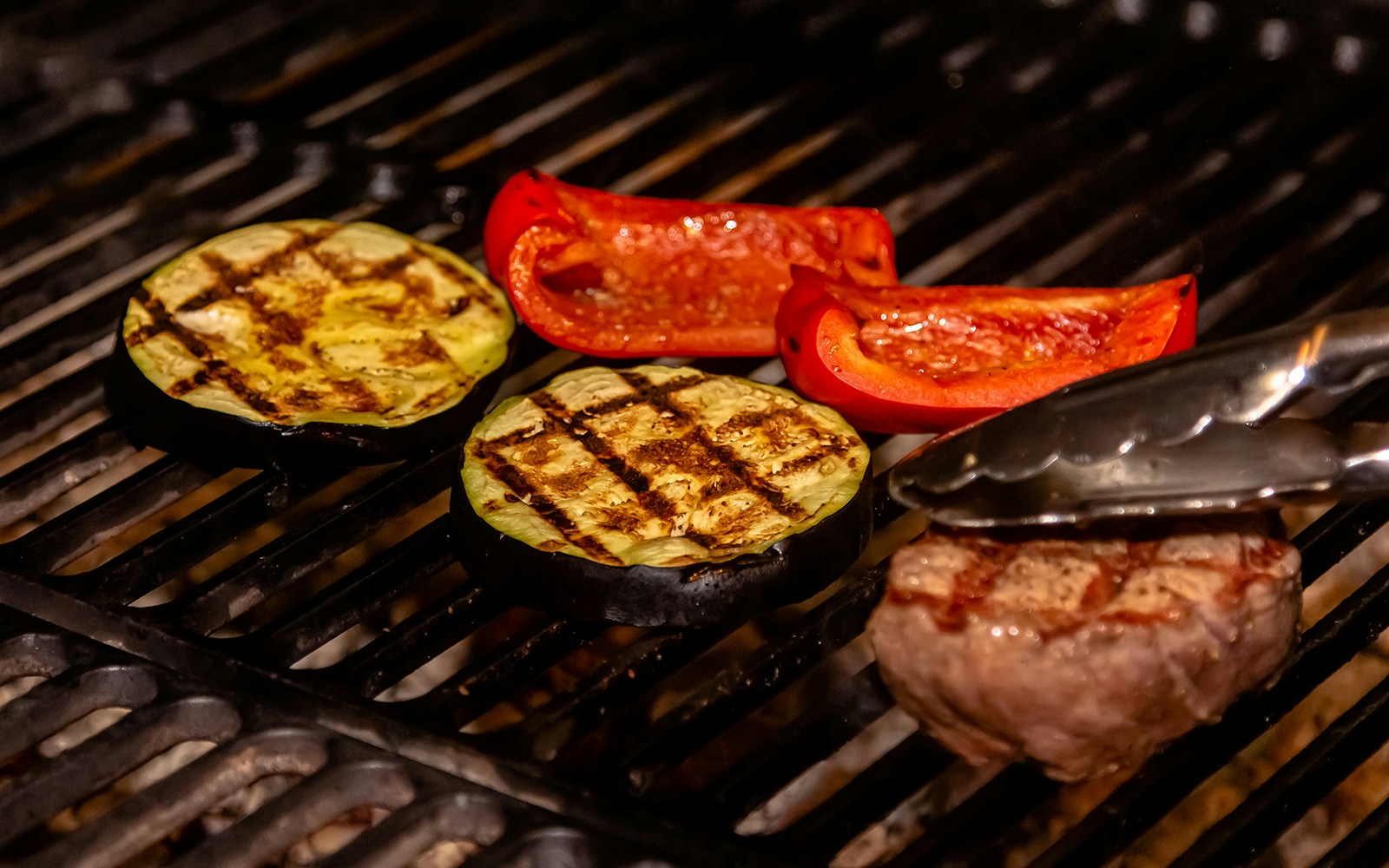 Beef, eggplant and sweet pepper are grilled on a charcoal grill