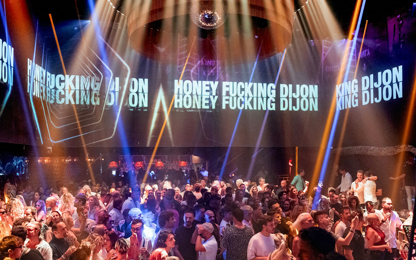 Honey Dijon DJing at Club Chinois, Ibiza, with a lively crowd enjoying the music.