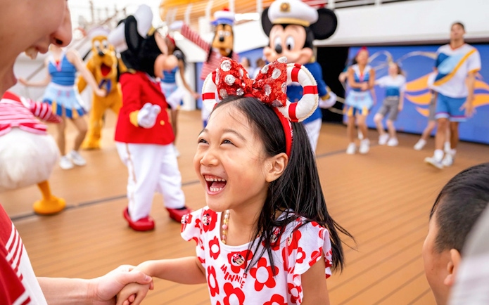 Child enjoying sail away party on Disney Adventure Cruise, Singapore.