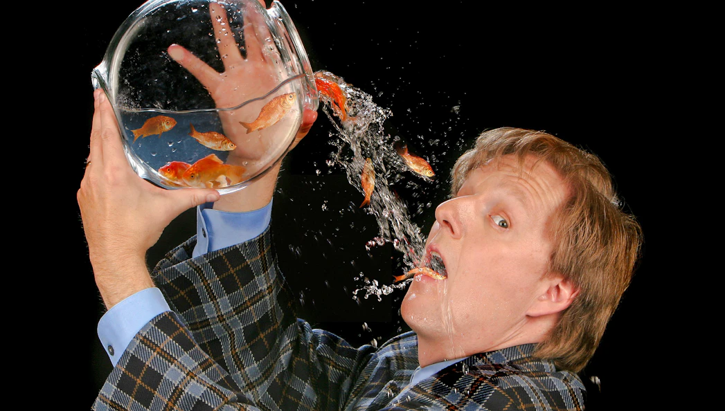 Magician performing goldfish trick at The Mac King Comedy Magic Show, Vegas.