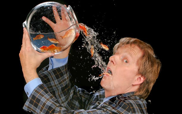 Magician performing goldfish trick at The Mac King Comedy Magic Show, Vegas.