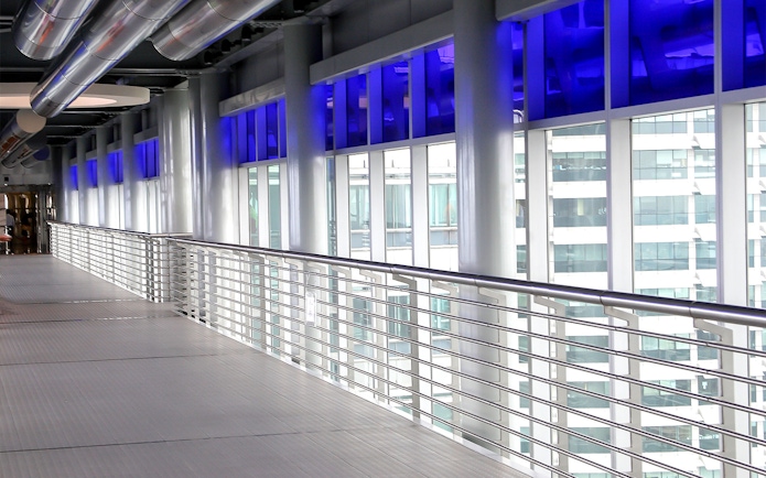 Skybridge interior at Petronas Twin Towers, Kuala Lumpur, with city view through windows.