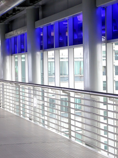 Skybridge interior at Petronas Twin Towers, Kuala Lumpur, with city view through windows.