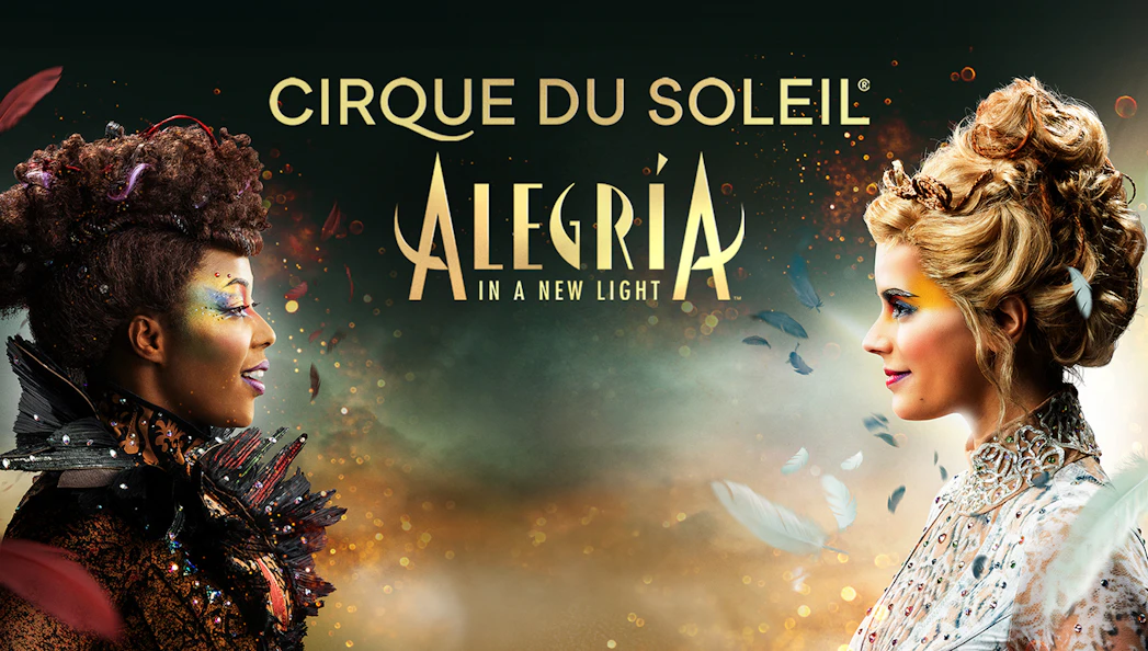 Cirque du Soleil Alegría performers facing each other with colorful makeup in Seville.