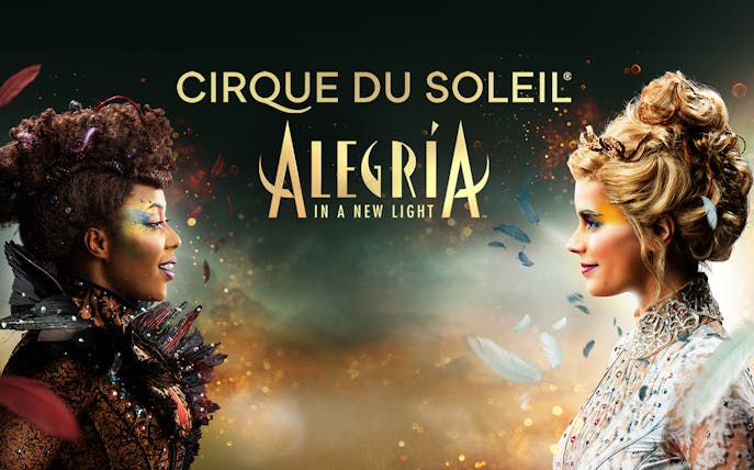 Cirque du Soleil Alegría performers facing each other with colorful makeup in Seville.