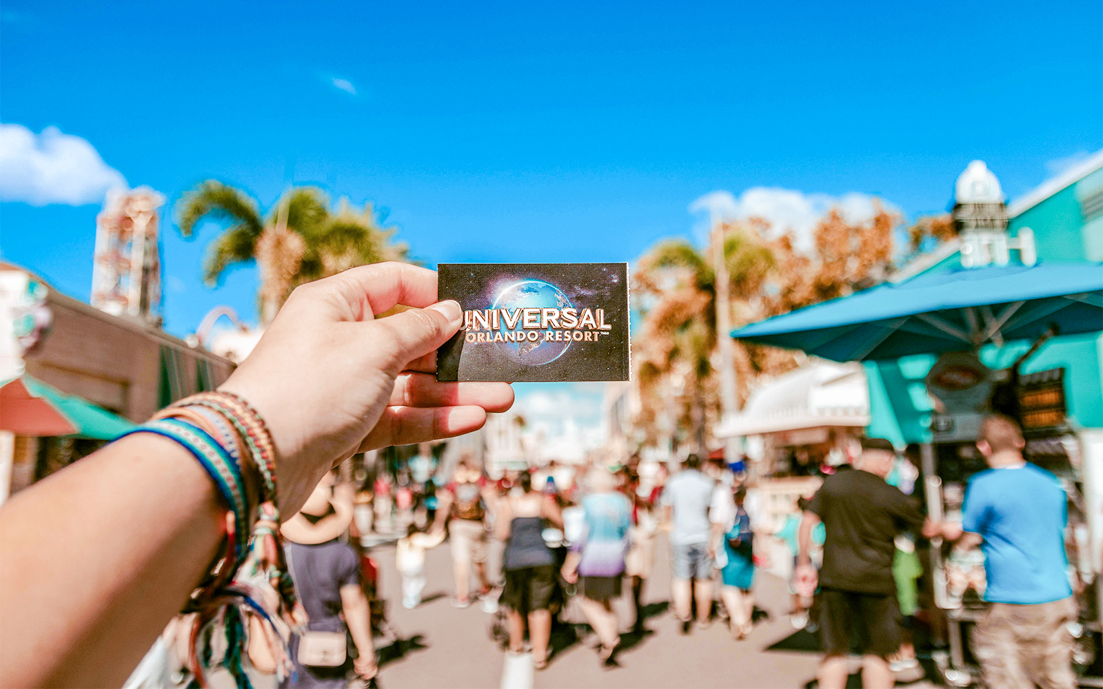 Universal Studios ticket held in hand at Universal Orlando, Florida.