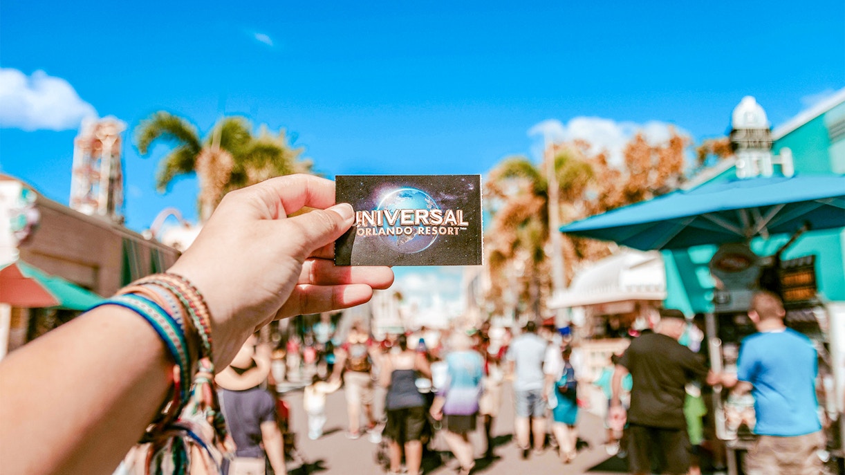 Universal Studios ticket held in hand at Universal Orlando, Florida.