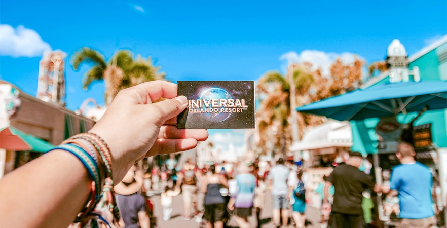 Universal Studios ticket held in hand at Universal Orlando, Florida.