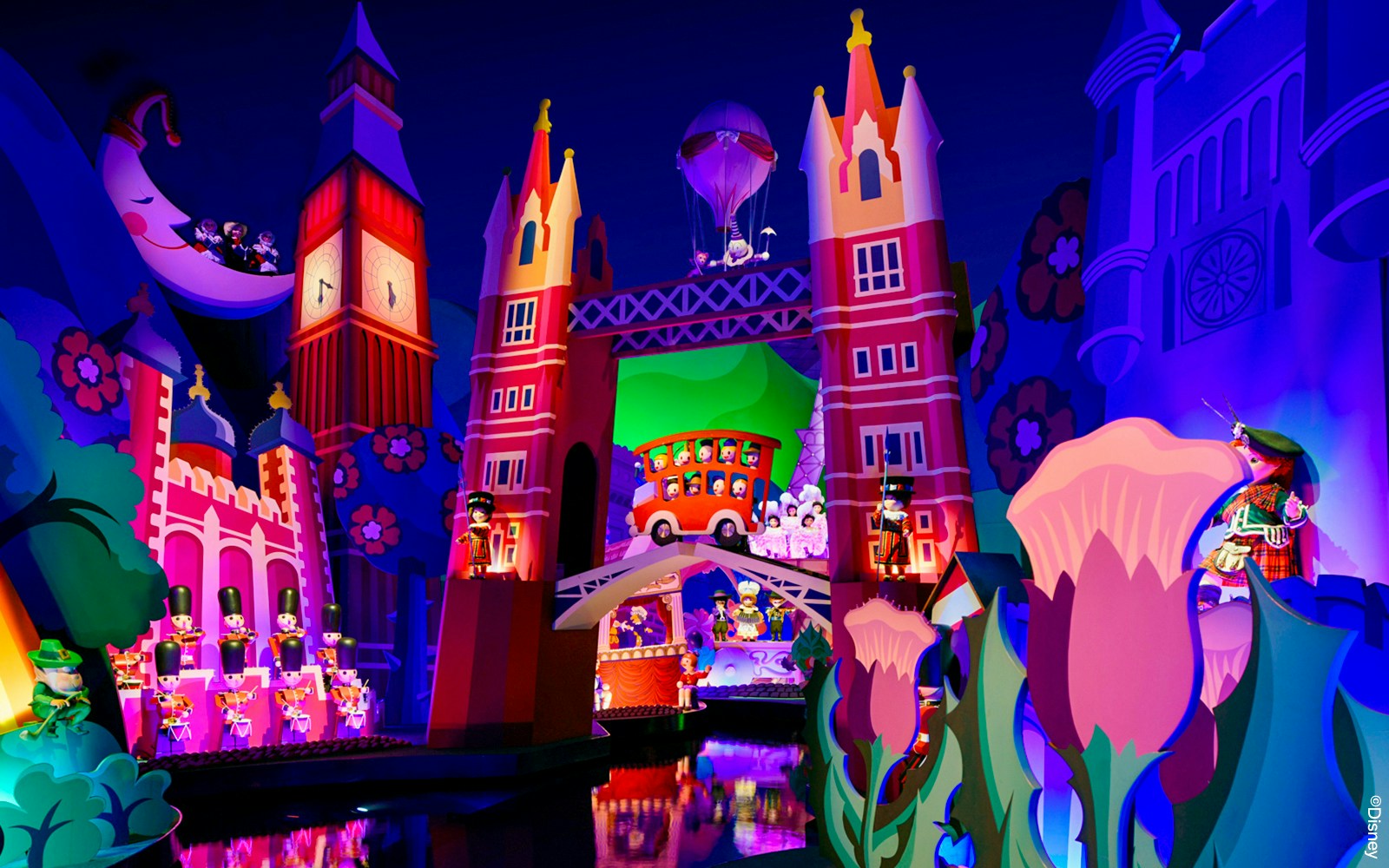 Small World boat ride at Disneyland Paris with colorful international dolls.