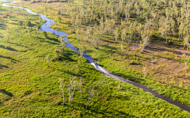 Aerial view of a boat on Finniss River during Top End Safari Camp tour near Darwin.