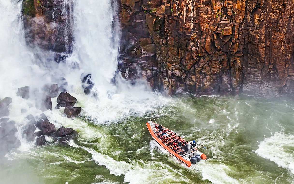 Gran Aventura boat navigating near waterfalls at Argentinian falls.
