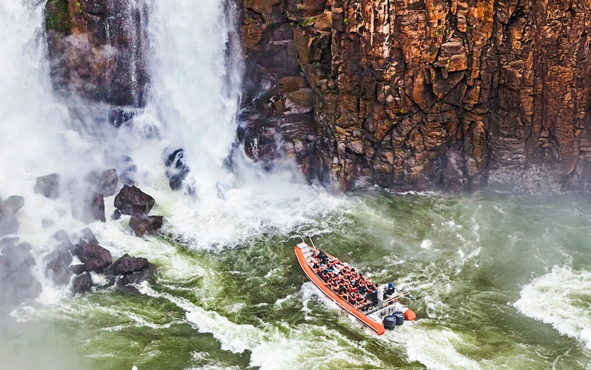 Gran Aventura boat navigating near waterfalls at Argentinian falls.