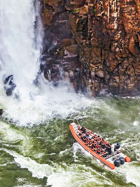 Gran Aventura boat navigating near waterfalls at Argentinian falls.