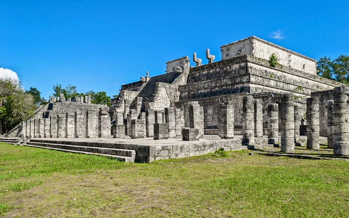 Temple of the Warriors at Chichen Itza, Yucatan, Mexico, with stone columns and steps.