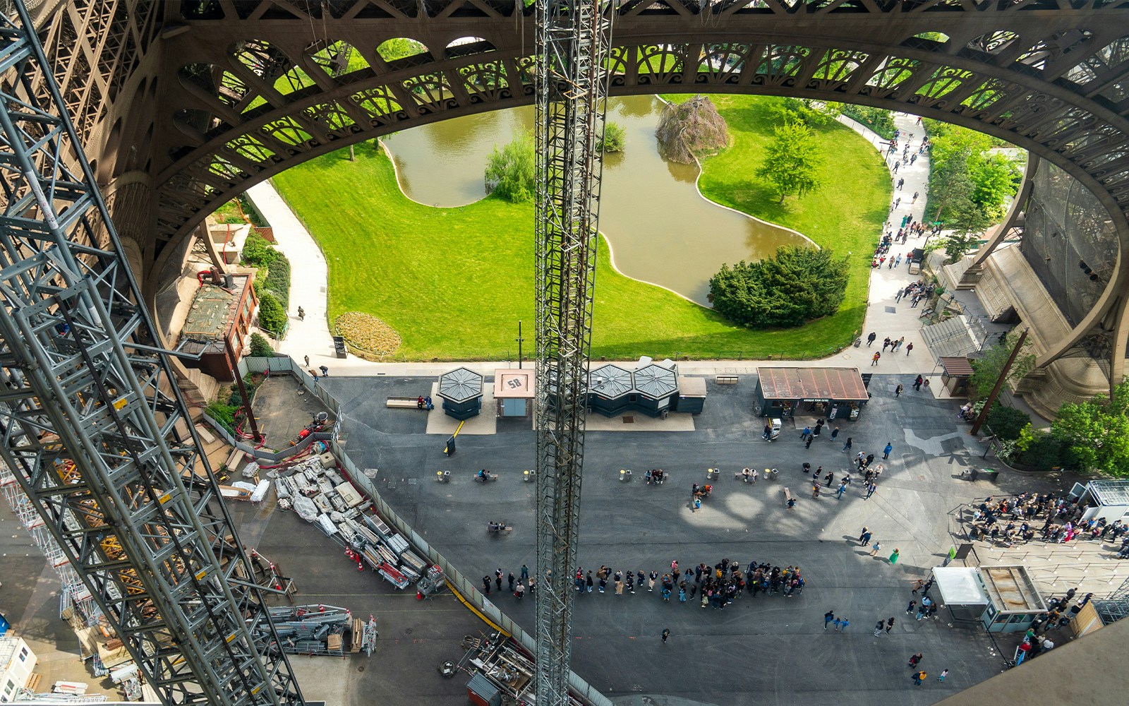 Eiffel Tower elevator with host guiding visitors to summit or second floor in Paris.