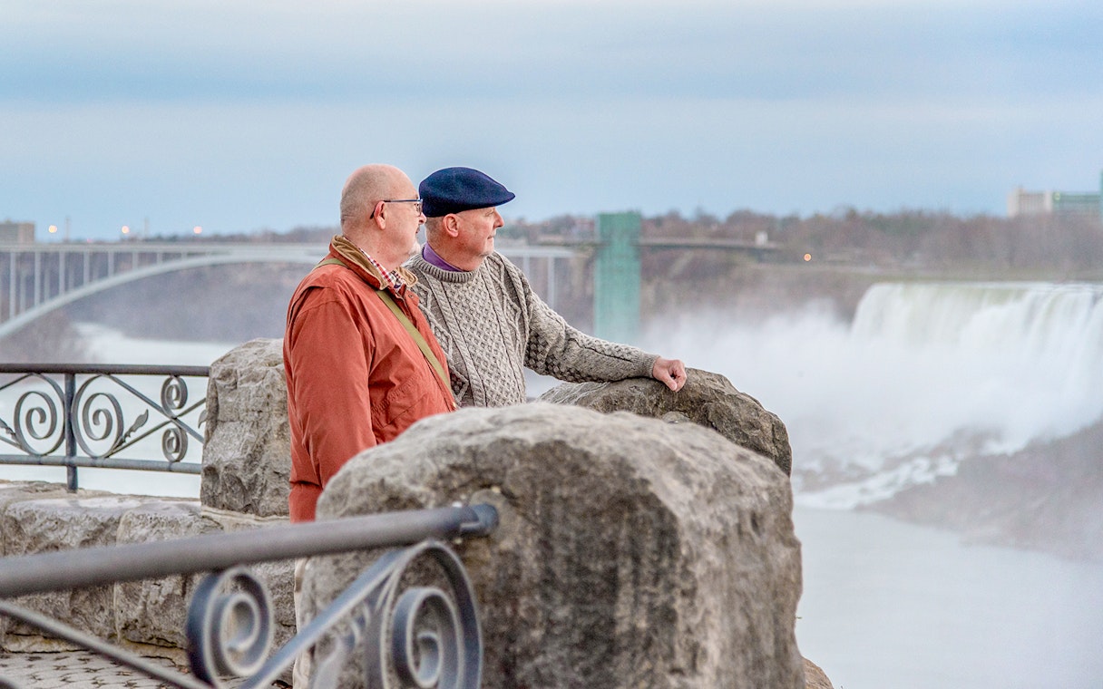 Visitors enjoying the view of Niagara Falls from a lookout point in Canada.
