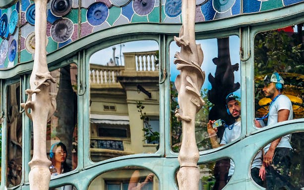 Visitors using audio guides inside Casa Batlló, Barcelona.