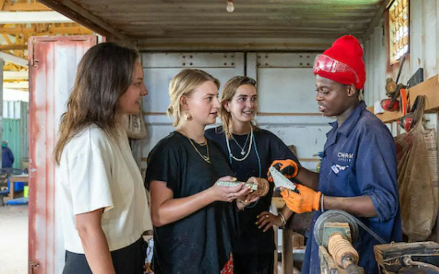 Visitors learning upcycling techniques in a workshop during Zanzibar Stone Town Walking Tour.