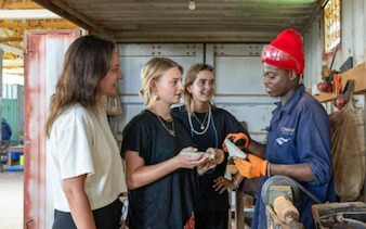 Visitors learning upcycling techniques in a workshop during Zanzibar Stone Town Walking Tour.