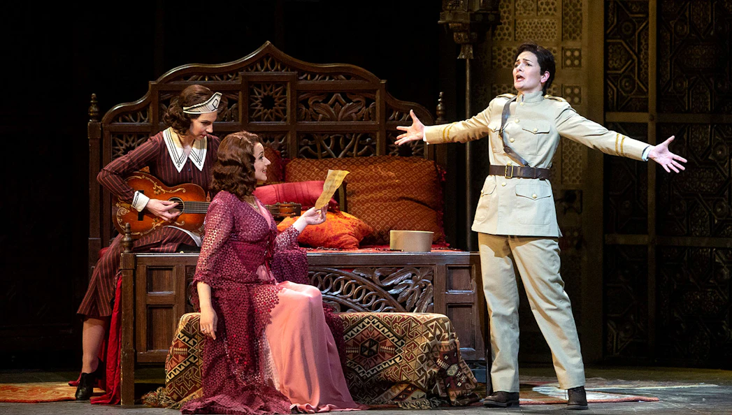 Opera performers in a scene from Le Nozze Di Figaro, with one holding a letter.