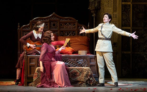 Opera performers in a scene from Le Nozze Di Figaro, with one holding a letter.