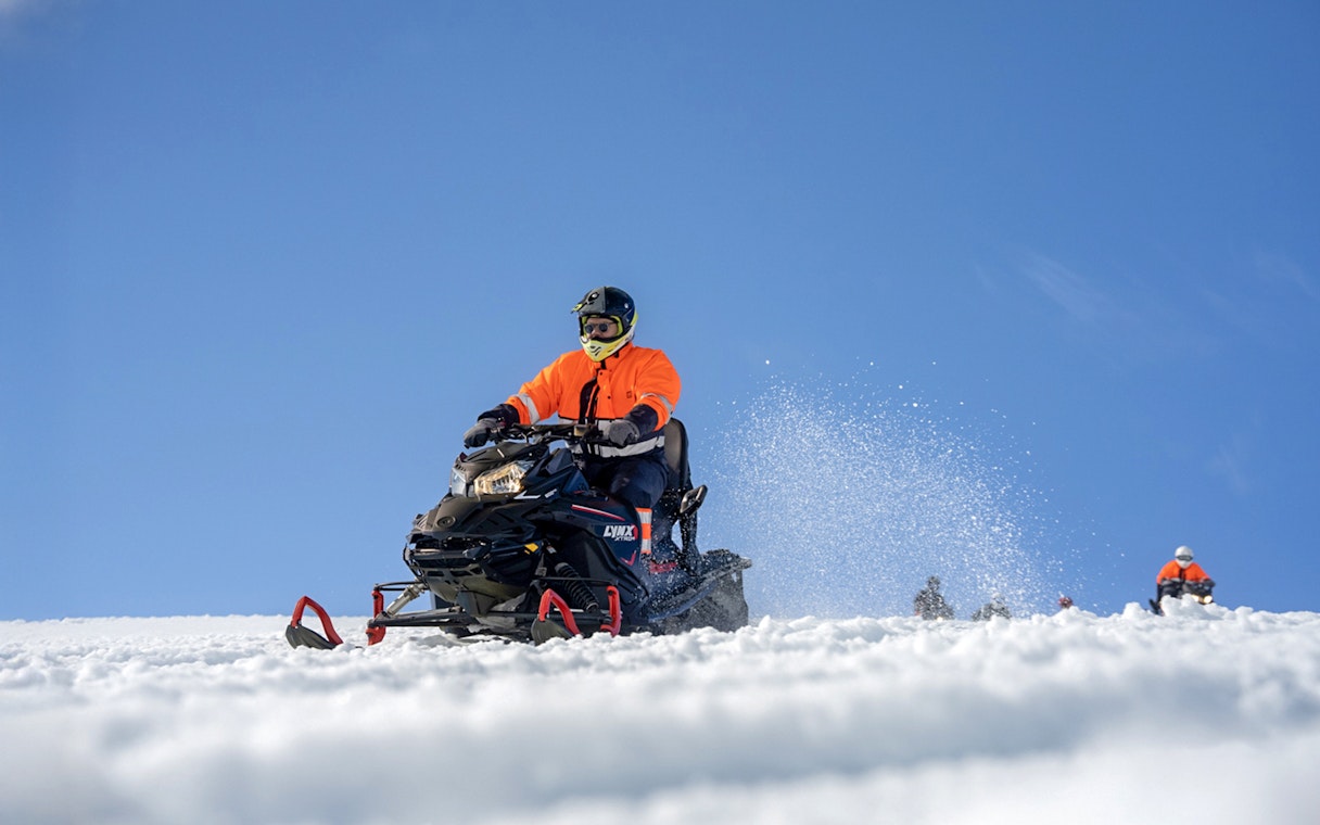 Snowmobile riders on Langjökull Glacier, Iceland, enjoying a winter adventure.