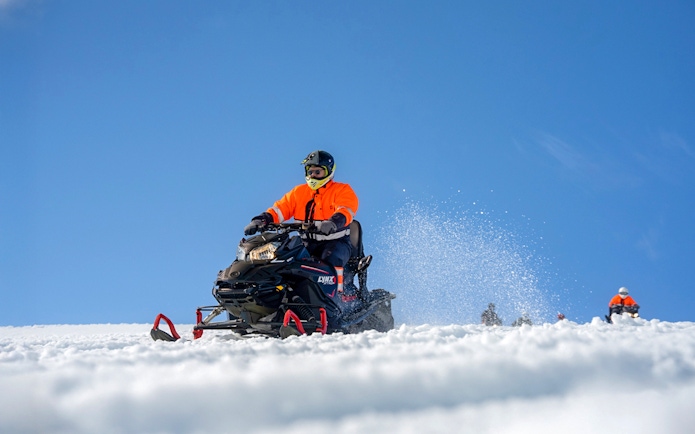 Snowmobile riders on Langjökull Glacier, Iceland, enjoying a winter adventure.