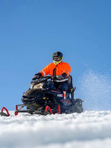 Snowmobile riders on Langjökull Glacier, Iceland, enjoying a winter adventure.