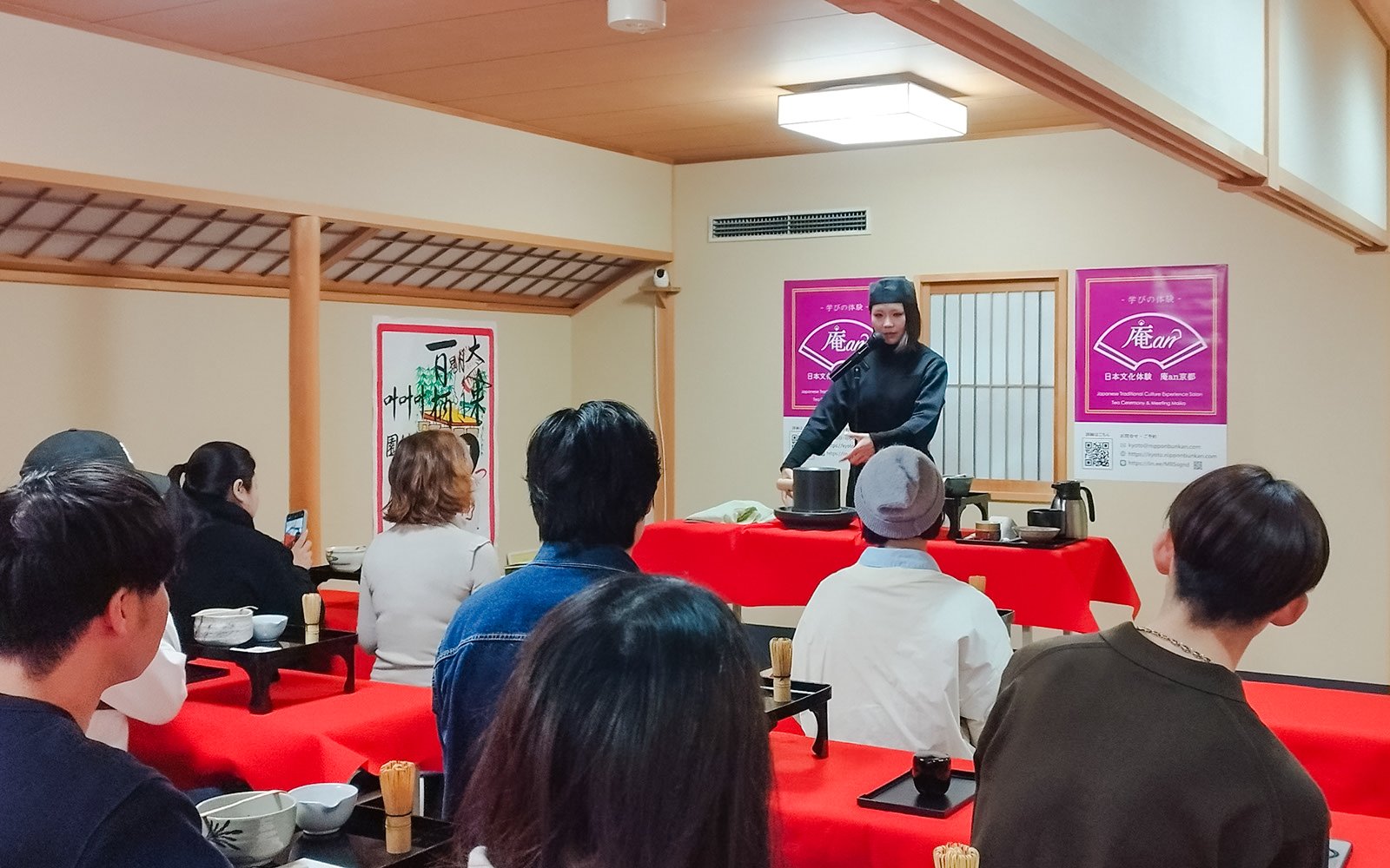 Tea ceremony demonstration in Kyoto Karasuma area with participants observing.