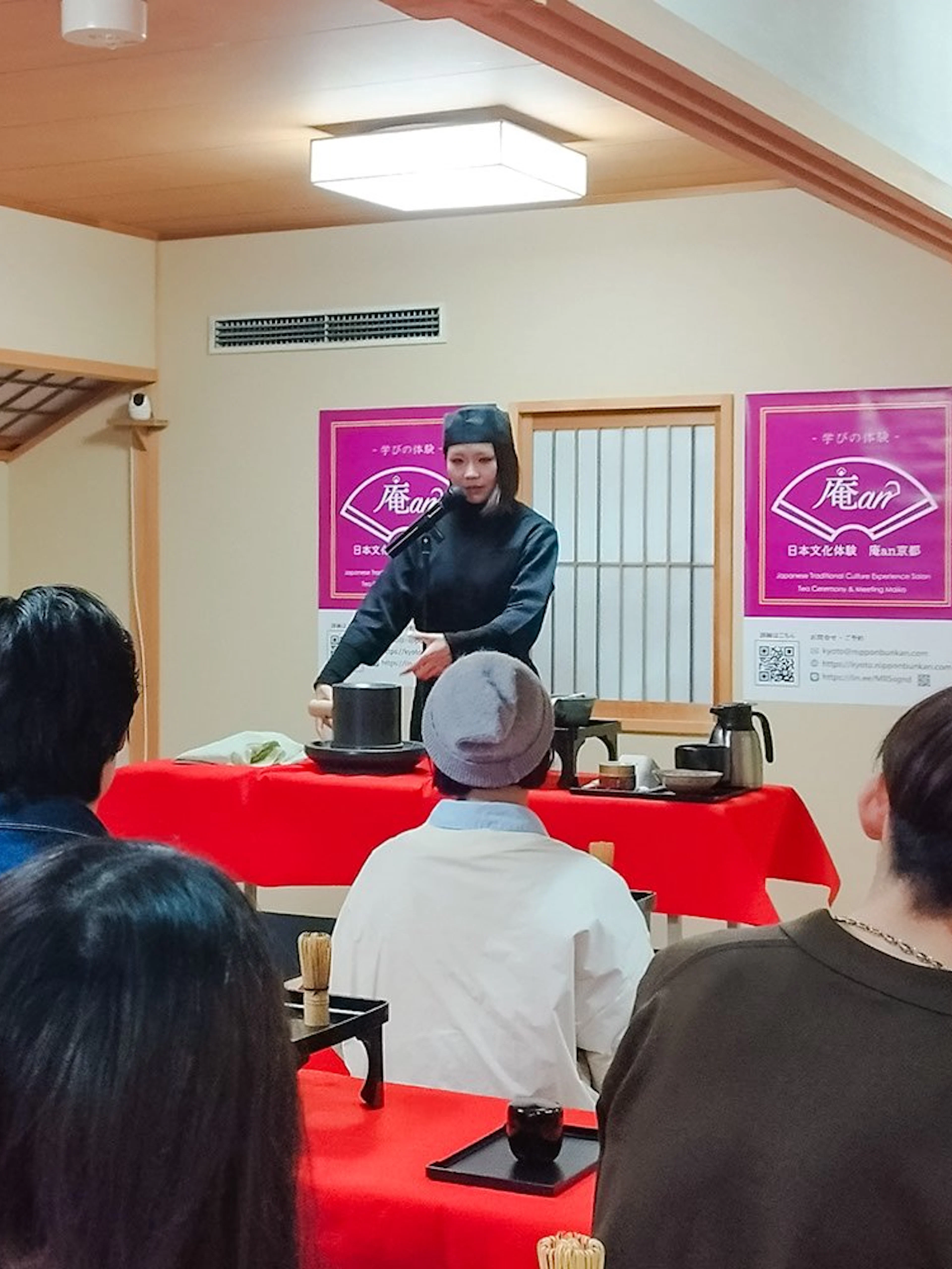 Tea ceremony demonstration in Kyoto Karasuma area with participants observing.