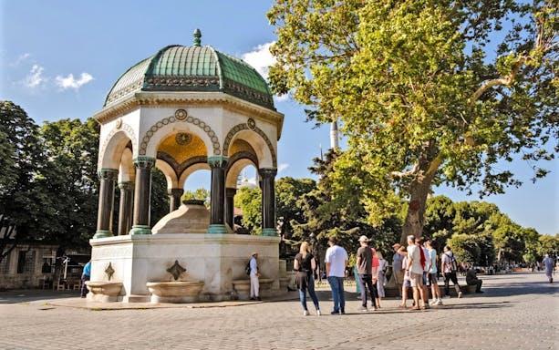 German Fountain in Istanbul, Turkey with tourists gathered around.