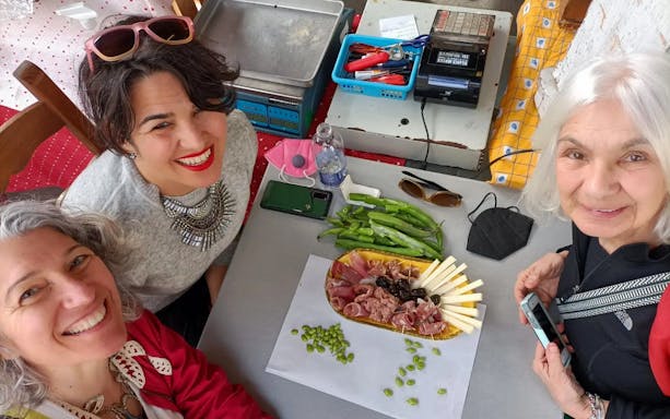 People enjoying a charcuterie platter during a guided street food tour in Florence.