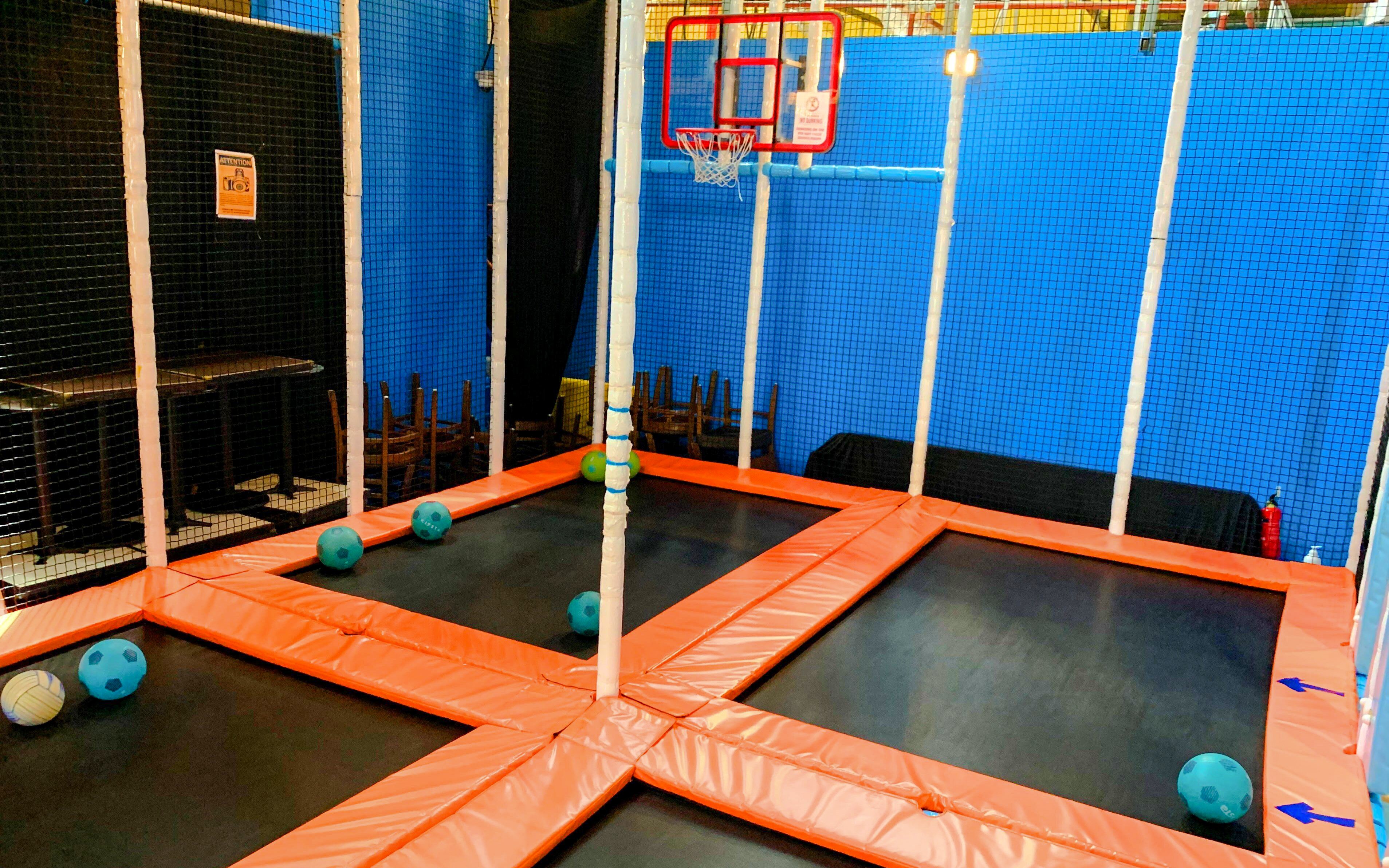 Trampoline basketball court at Amazonia Singapore indoor playground.