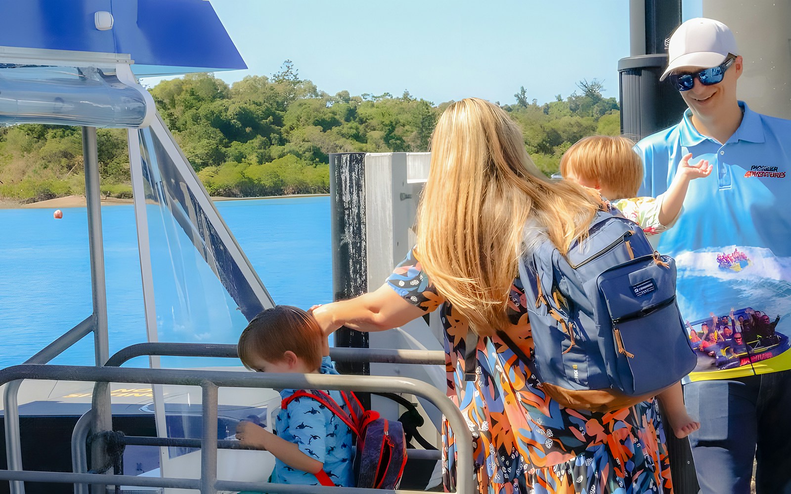 People observing marine life through glass floor on Airlie Beach Glass Bottom Boat tour.