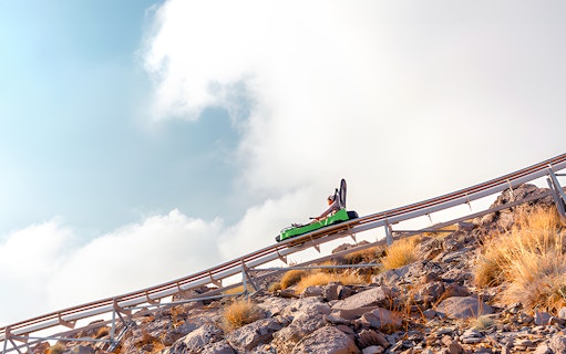 Solo rider on Jais Sledder descending mountain track, Ras Al Khaimah, UAE.