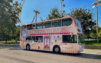 Afternoon Tea Bus parked near the London Eye, offering a unique sightseeing experience.